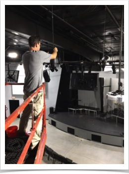 using a lift to reach into the ceiling by electrician working on an electrical lighting system